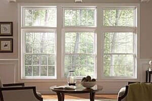 Worker installing a PVC vinyl window — Mezzo™ Energy Star window installation